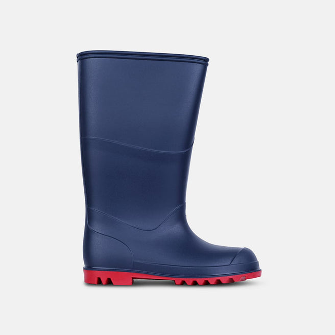 Classic Wellies Navy, a single rubber wellington boot in navy blue with a bright red sole, isolated on a light background.